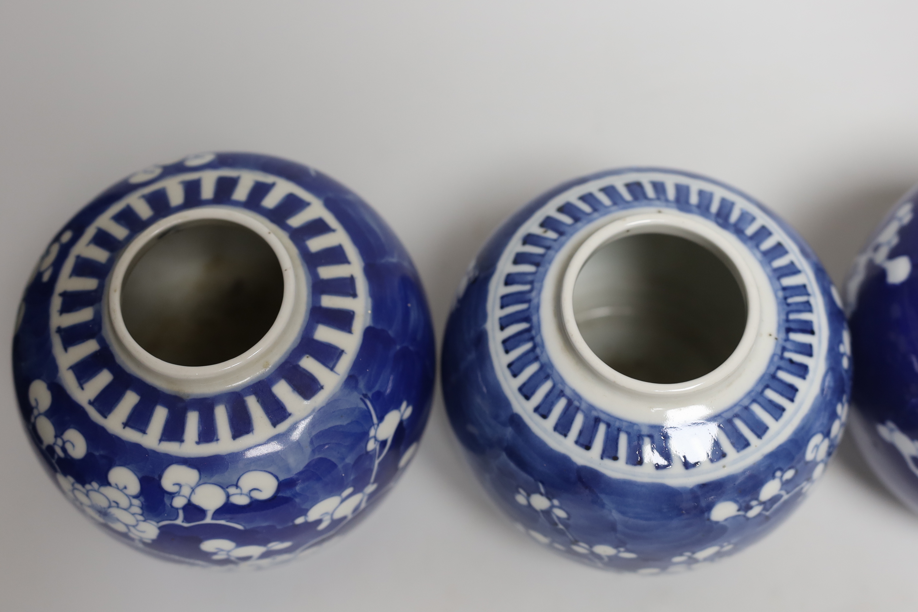 Five Chinese blue and white prunus ginger jars, one with cover- 15cm high and another jar